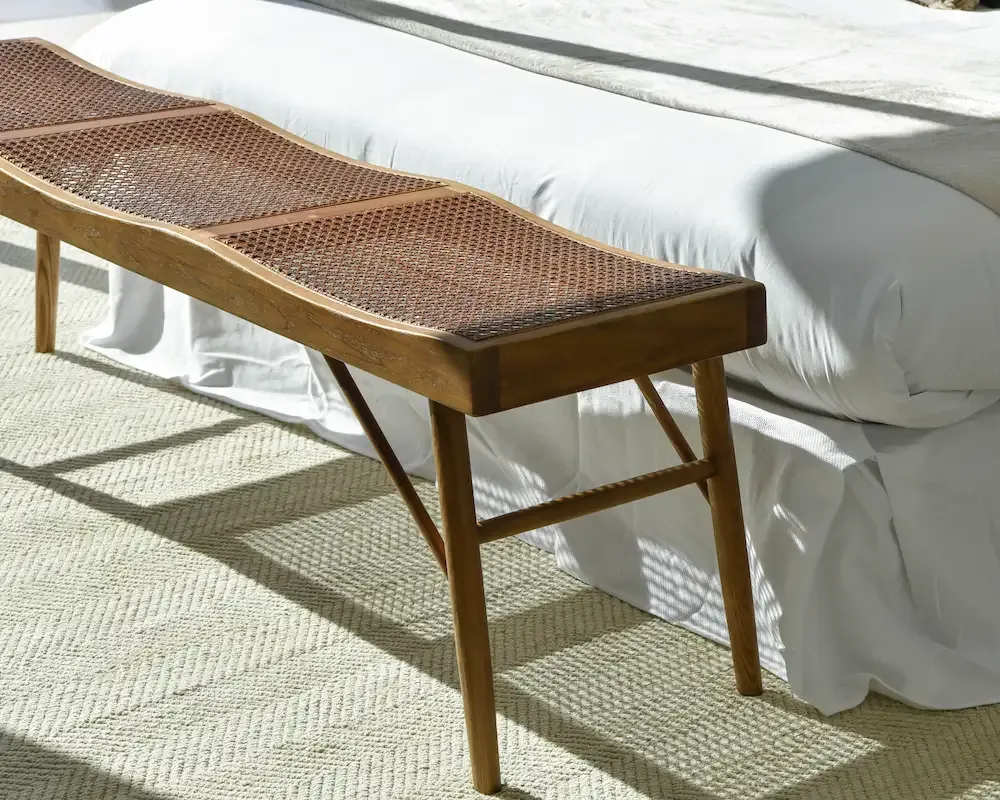 Elegant wood bench on the feet of the bed